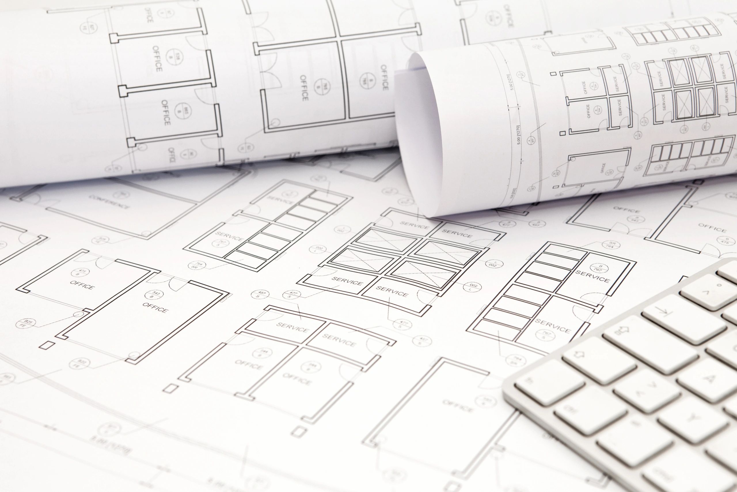 Rolled architectural blueprints on desk